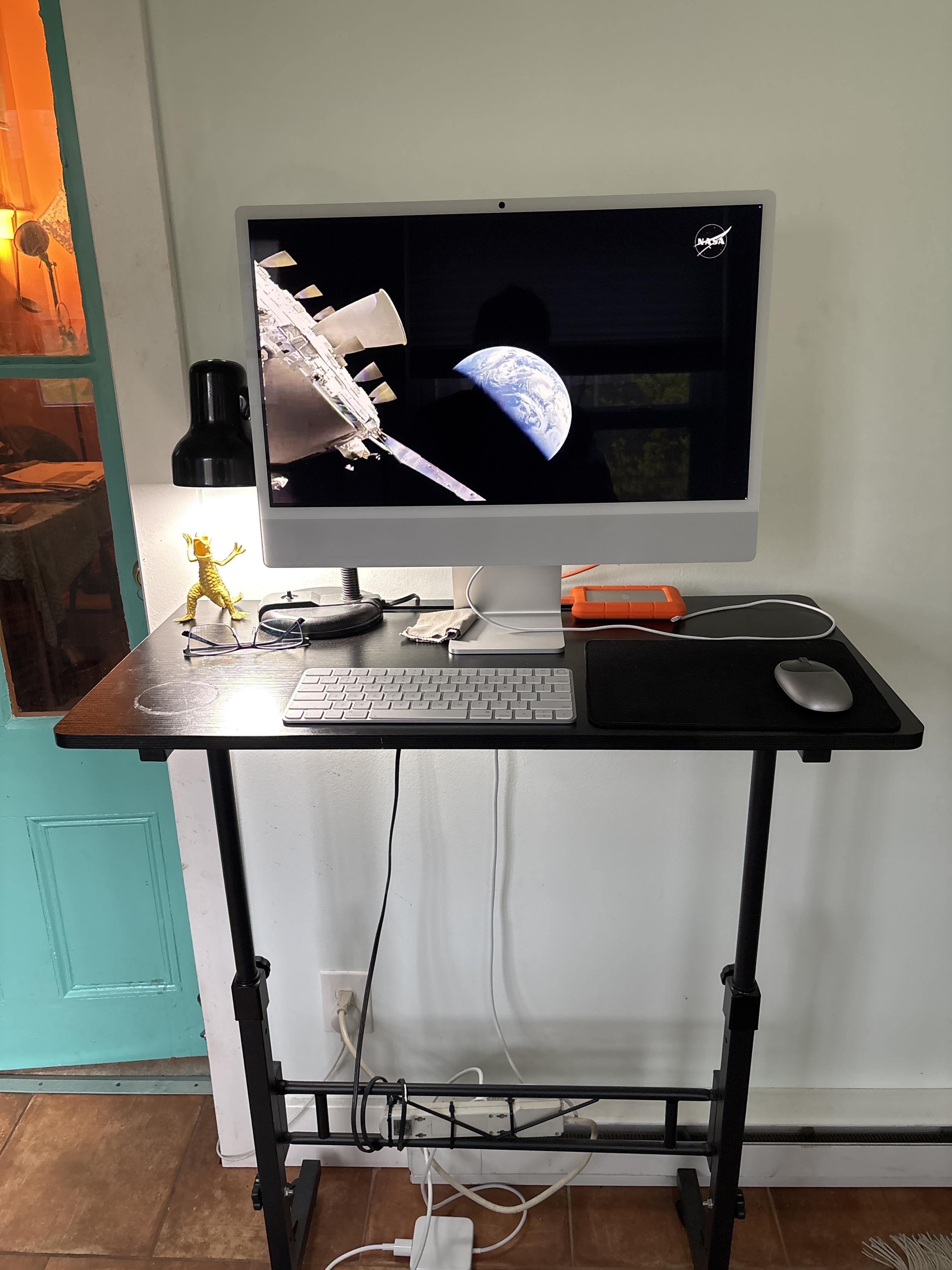 my standing workstation, displaying NASA video from Artemis of Earth, as they return from lunar orbit
