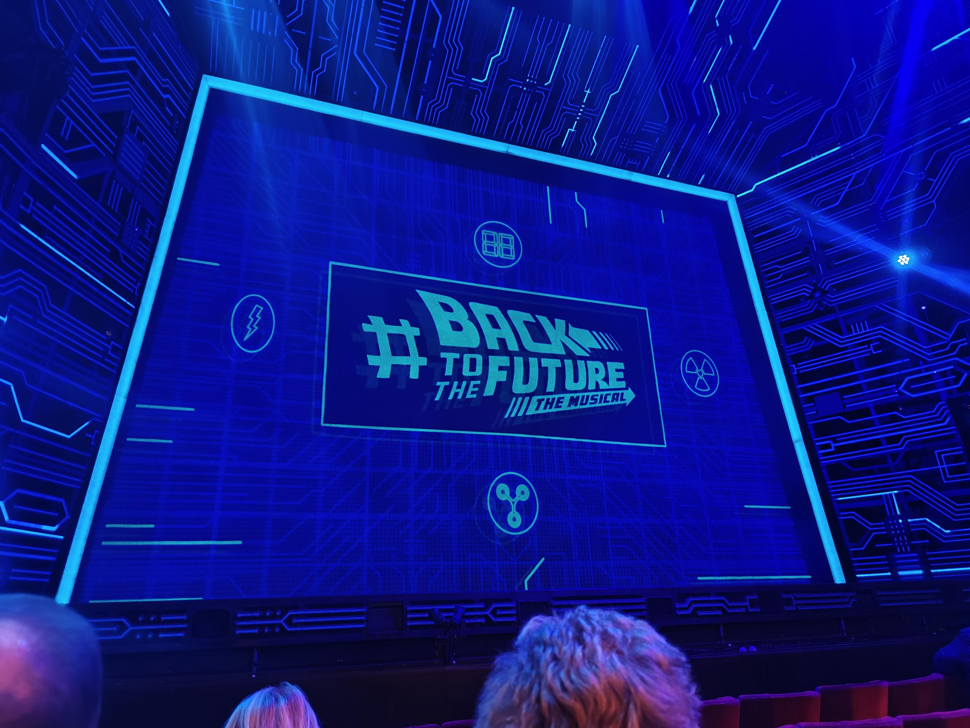 Picture of the welcome screen of the back to the future musical from my spot in the audience