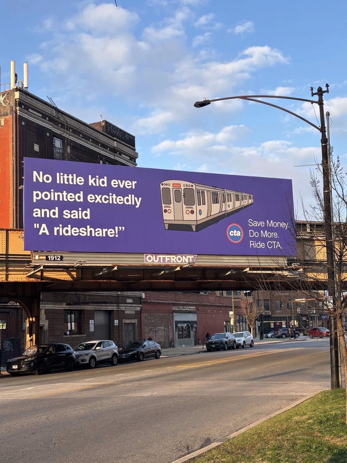 Billboard in a Chicago street next to an elevated  railway station. There’s a childlike line drawing of a train, and the tag reads: «No little kid ever pointed excitedly and said "A rideshare!" Save Money. Do More. Ride CTA.»