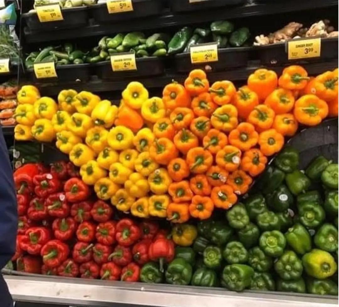A picture of the vegetable section of a supermarket with different types of peppers, some of which form a bell shape referencing the normal distribution in probability