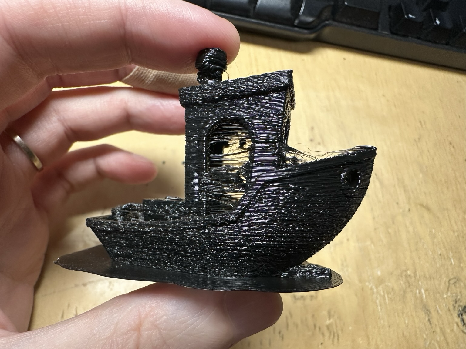 A very messy looking Benchy with horrible stringing.