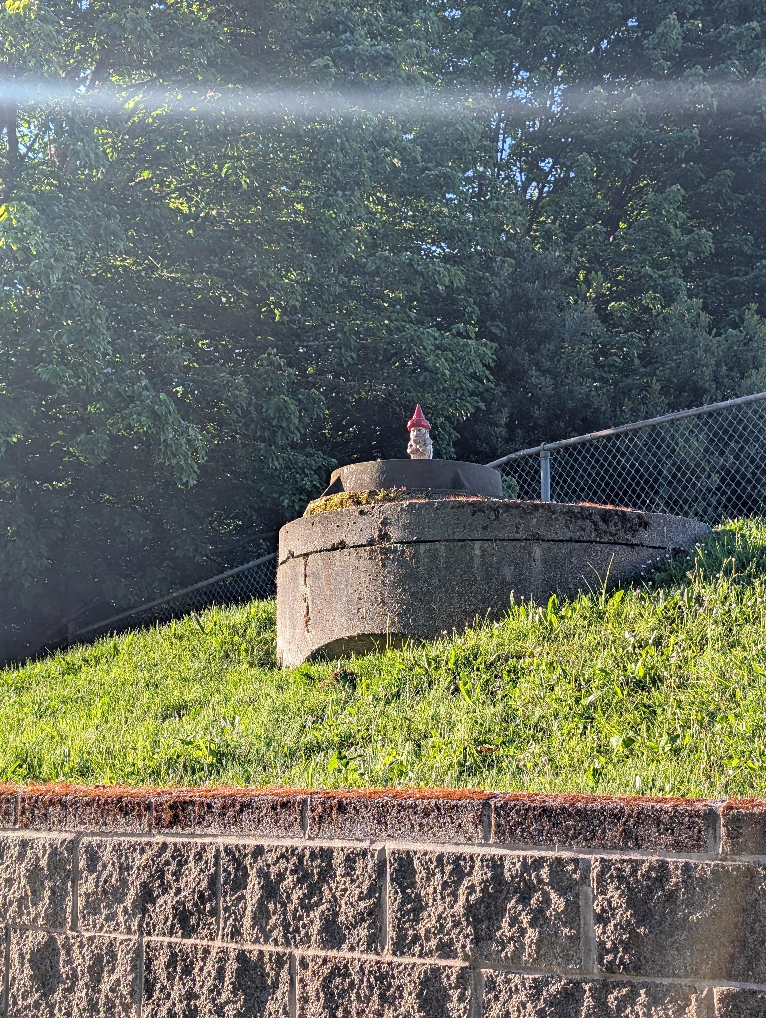 Gnome perched on a manhole
