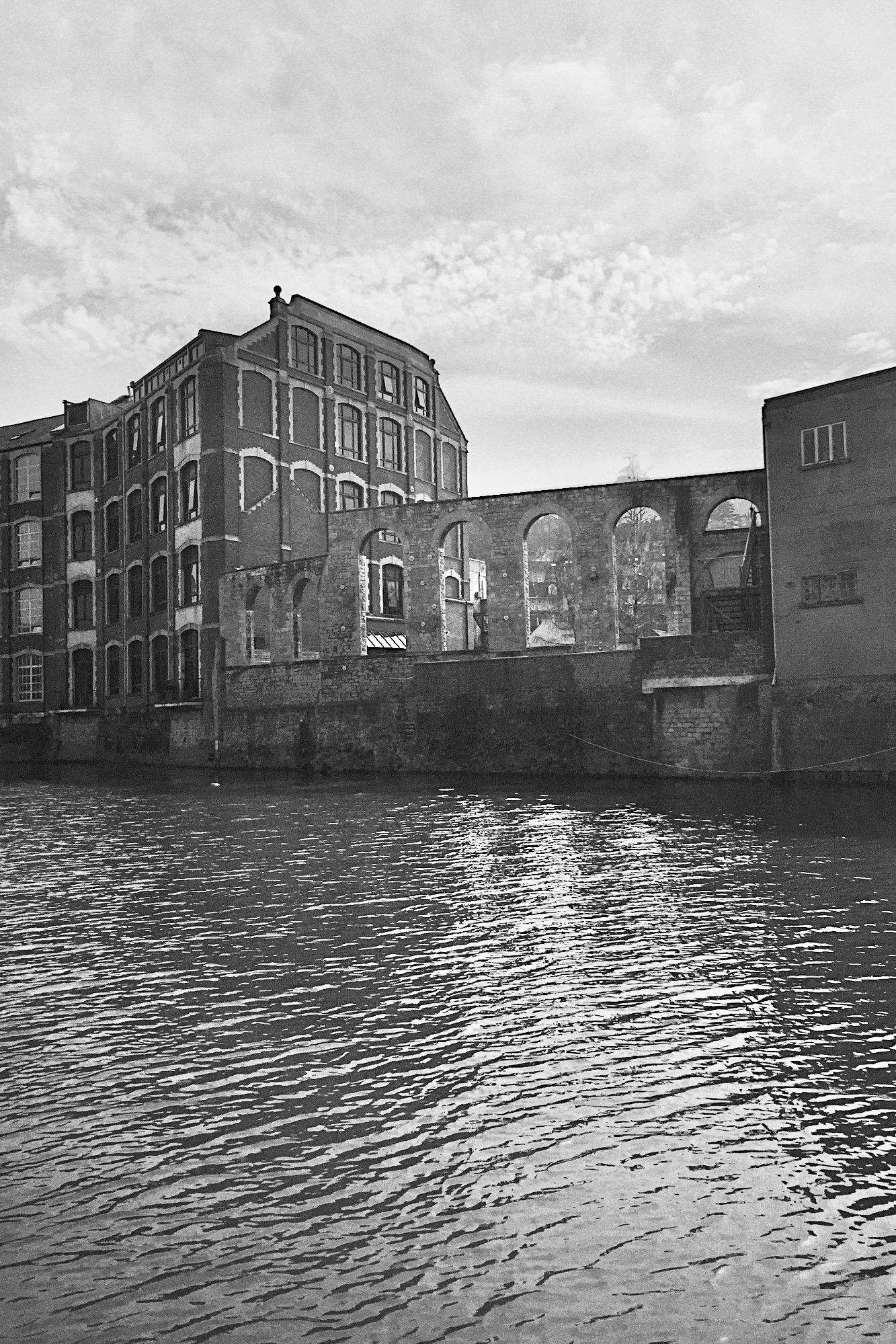 A black and white photo of old buildings next to the river Avon in Bath. 2015.