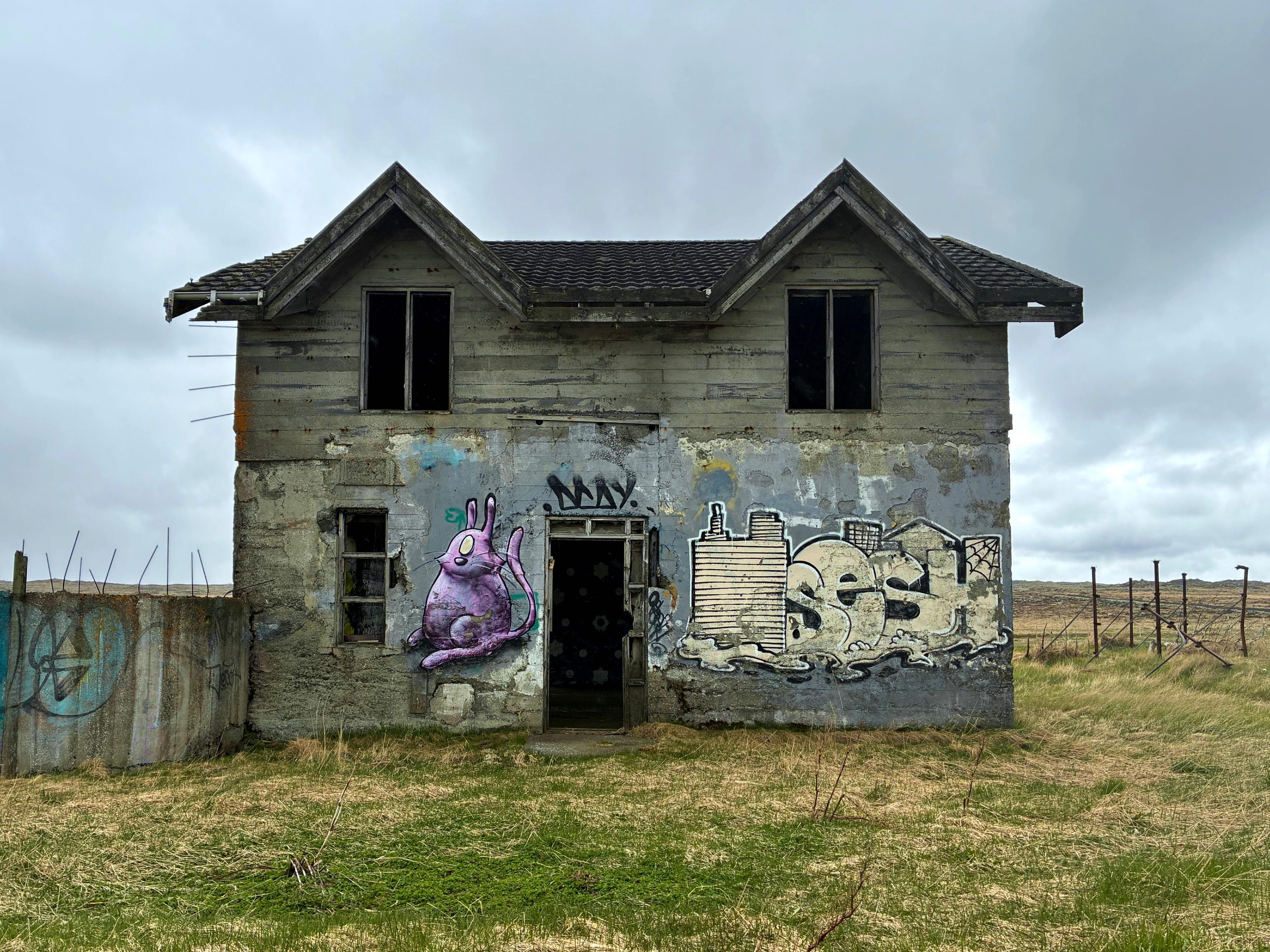 An abandoned concrete farmhouse.