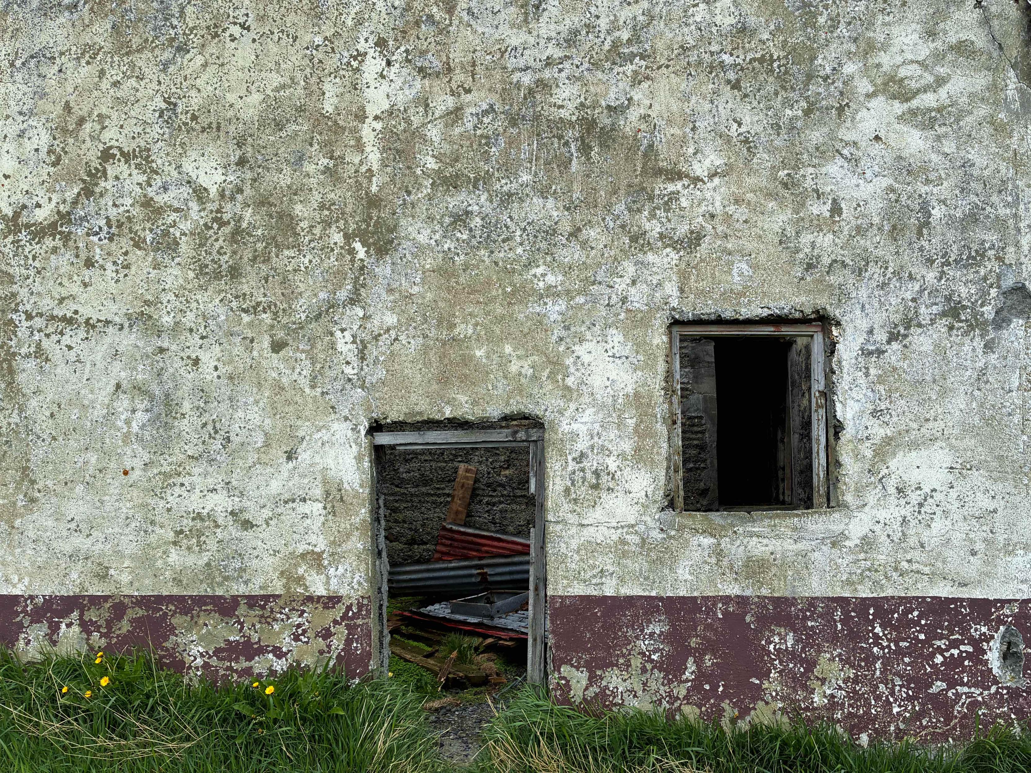 A small door and window to an abandoned barn.