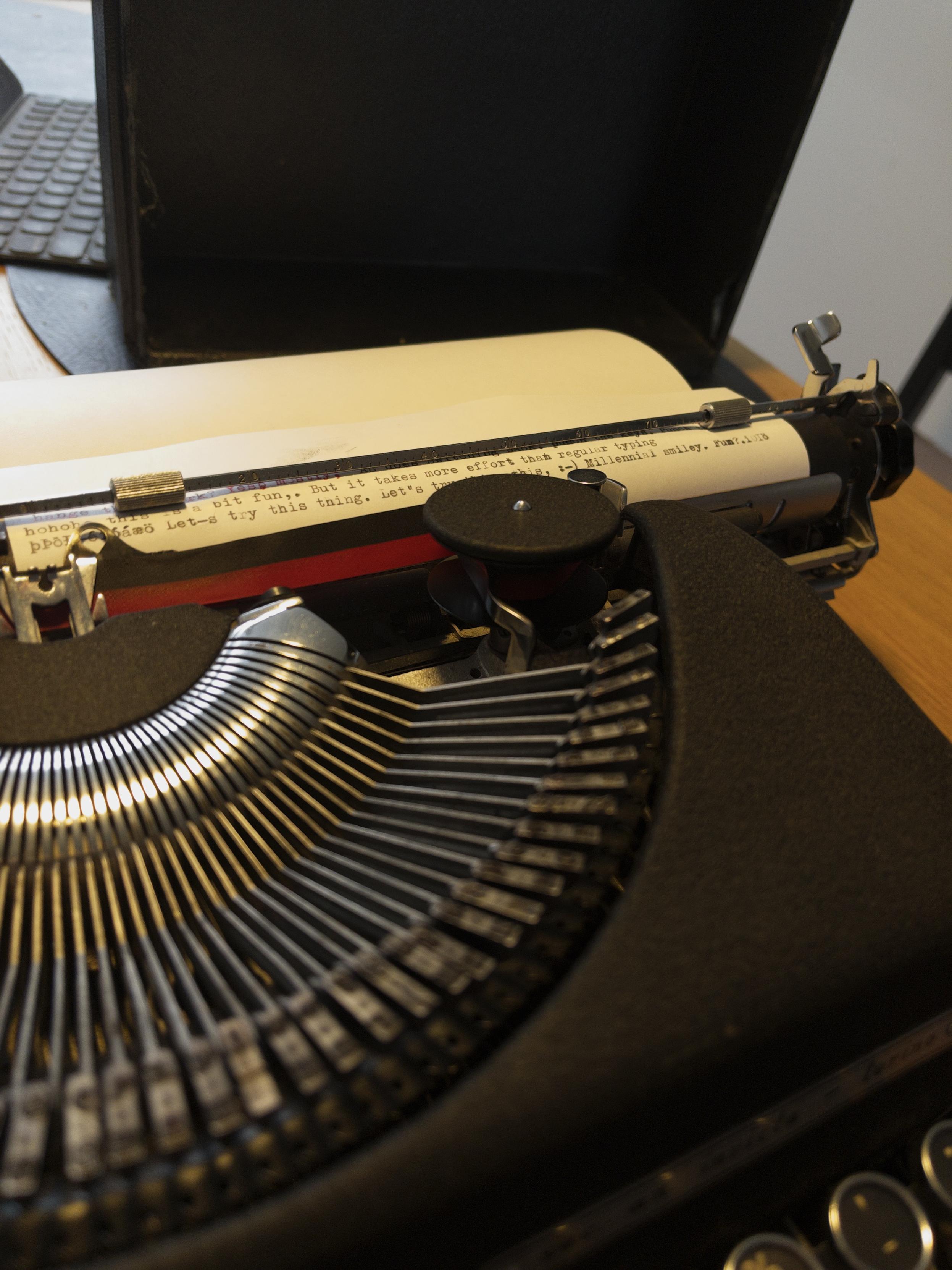 A picture of a manual typewriter with some text typed out on a page