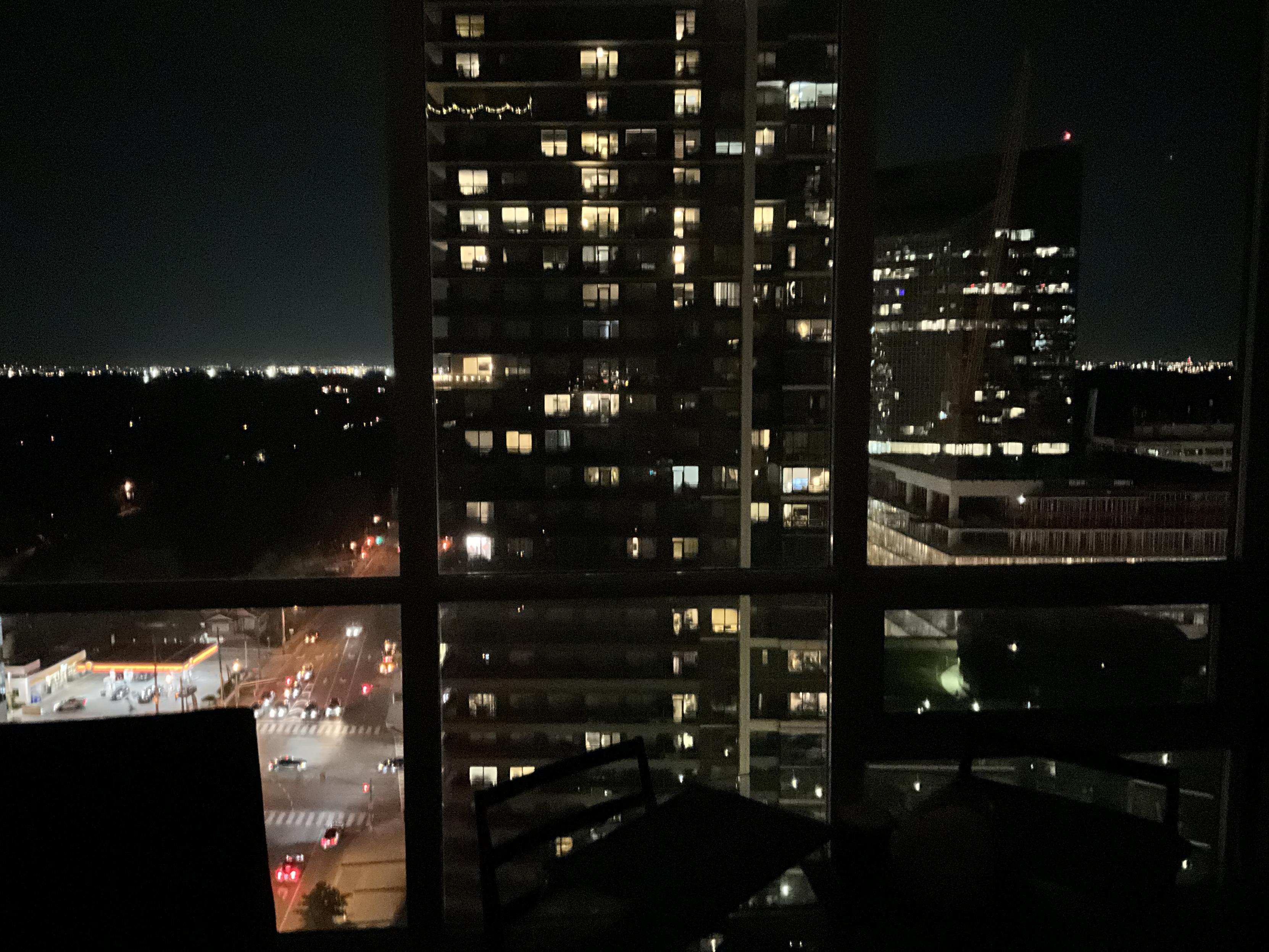 night image of Toronto buildings through a window with dividers