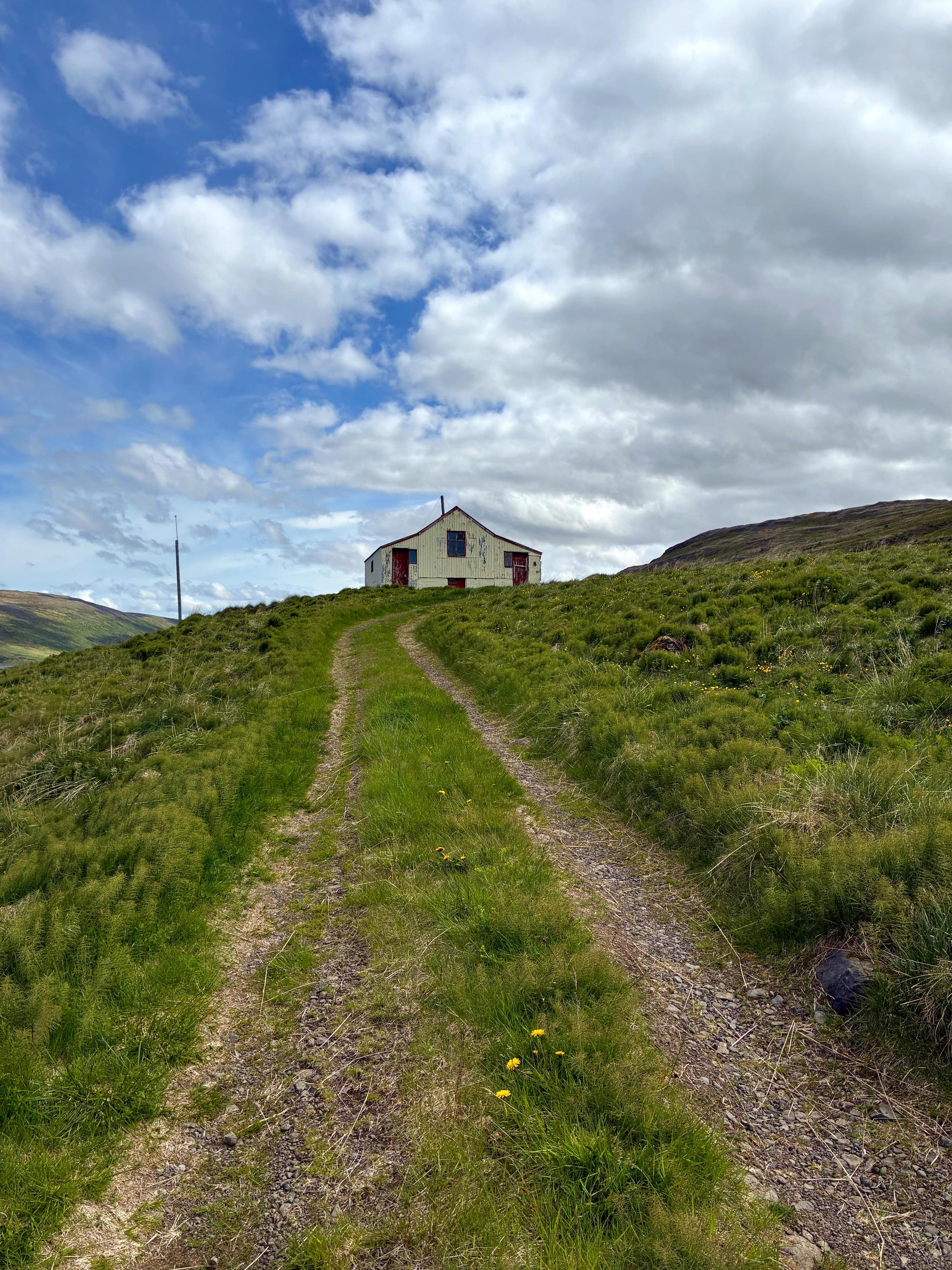 Small abandoned house on a hill.