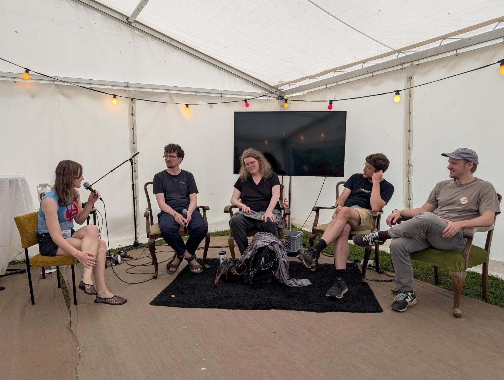 People sitting in a panel. From the left: Sammy, Andreas, Christine, Matthew, Daniel.