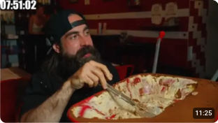 beard meets food is looking a bit challenged while he digs into what i really can only describe as a wheelbarrow full of tiramisu