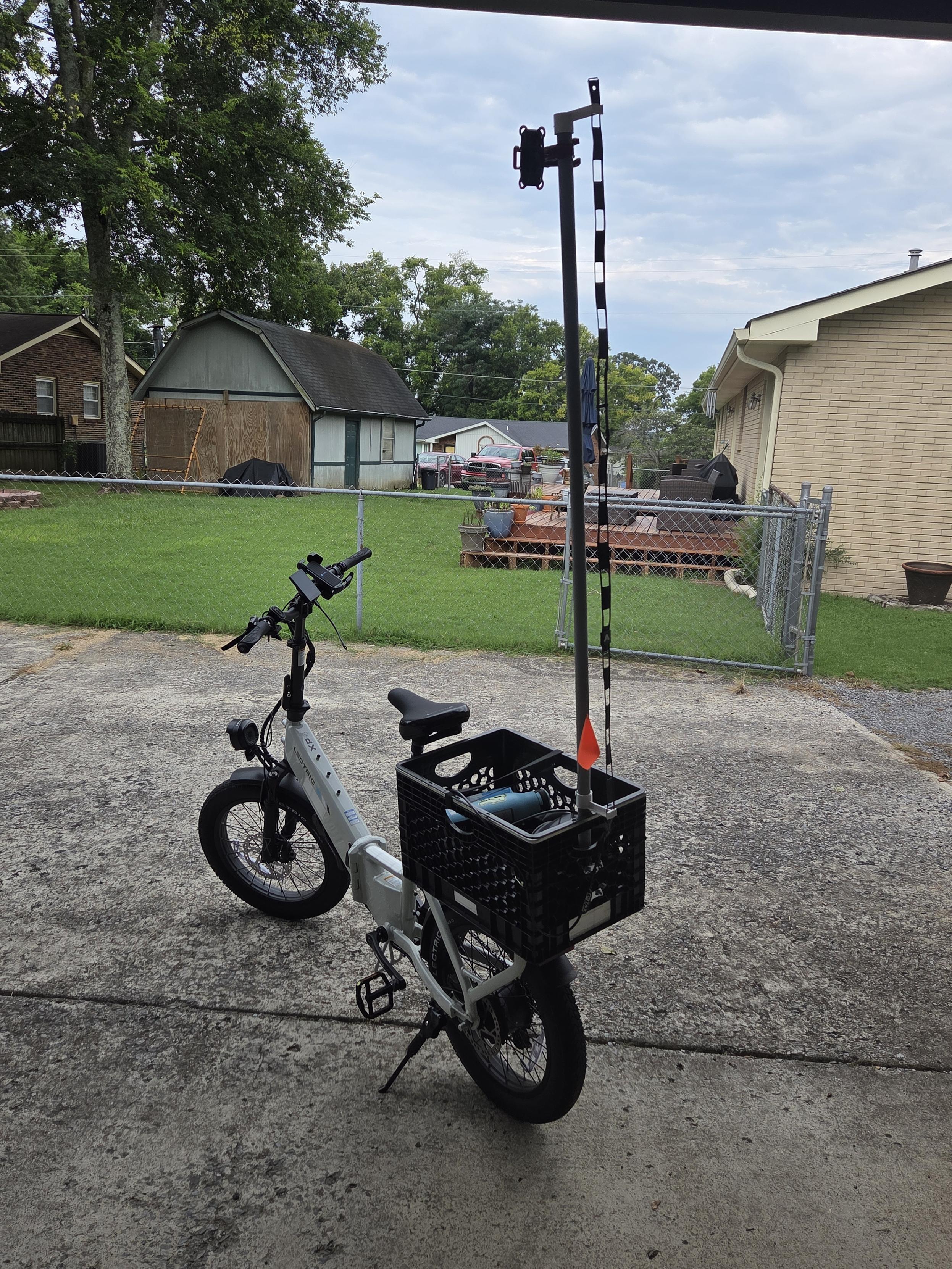 my Lectric XP4 750, sporting a milk crate on the back with a pvc pipe mast bearing a small mesh transceiver and a ladder line j-pole antenna.  radio nerd stuff.
