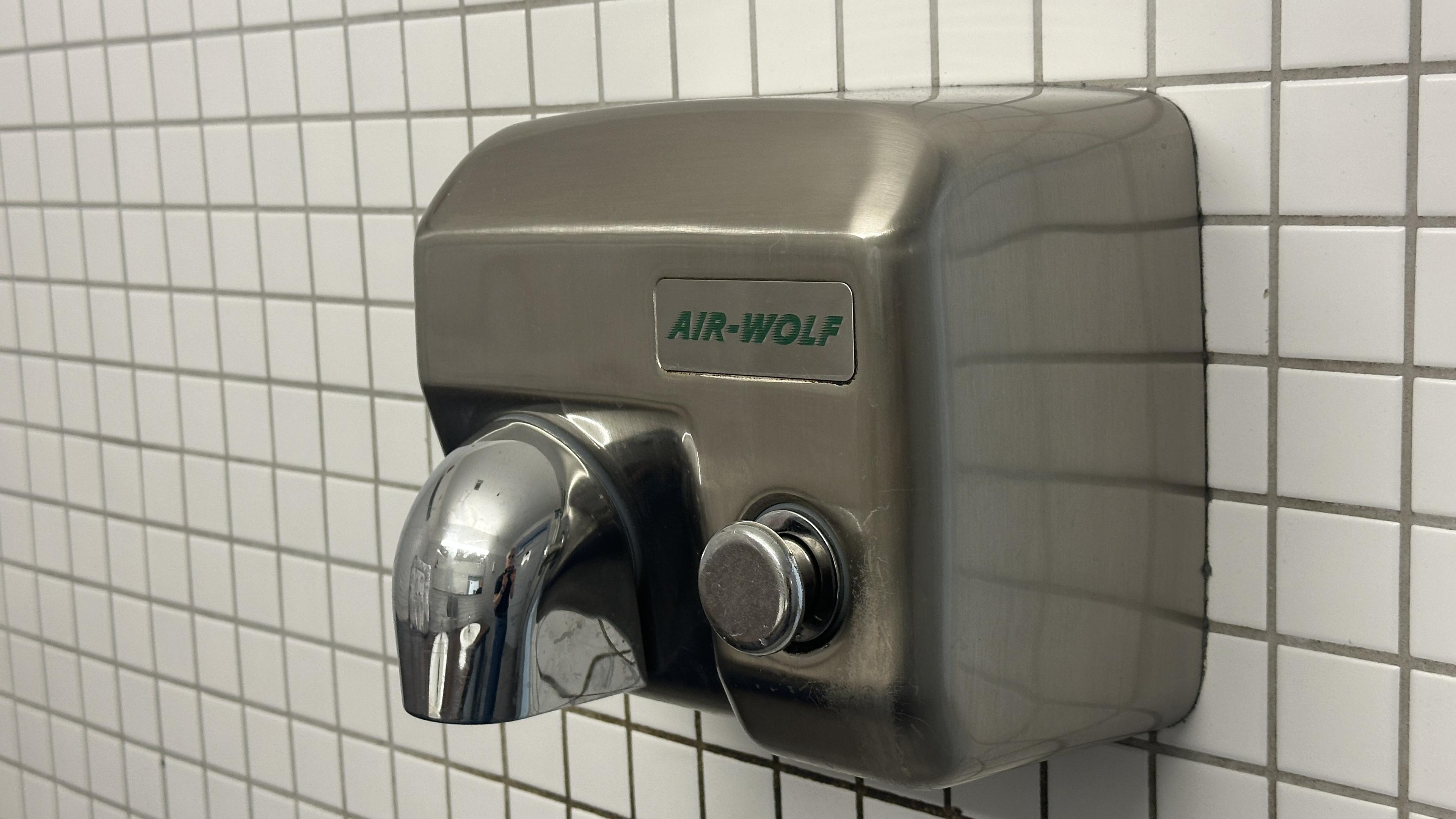 Hand dryer labeled Air Wolf, presumably after the 1980s tv show about the helicopter.