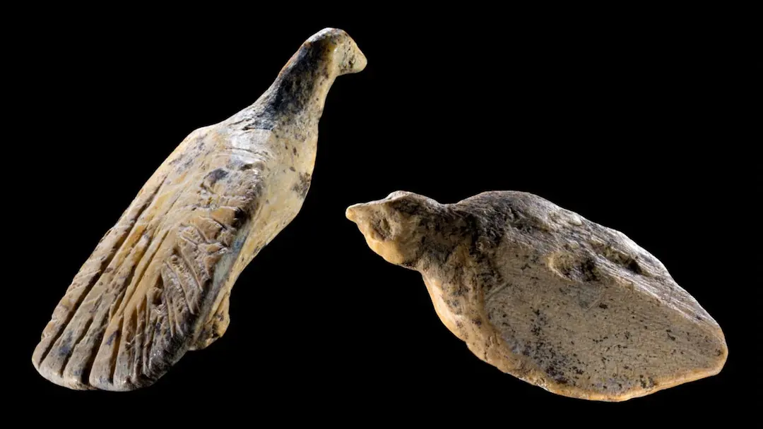 A close-up photo of the two tiny figurines.