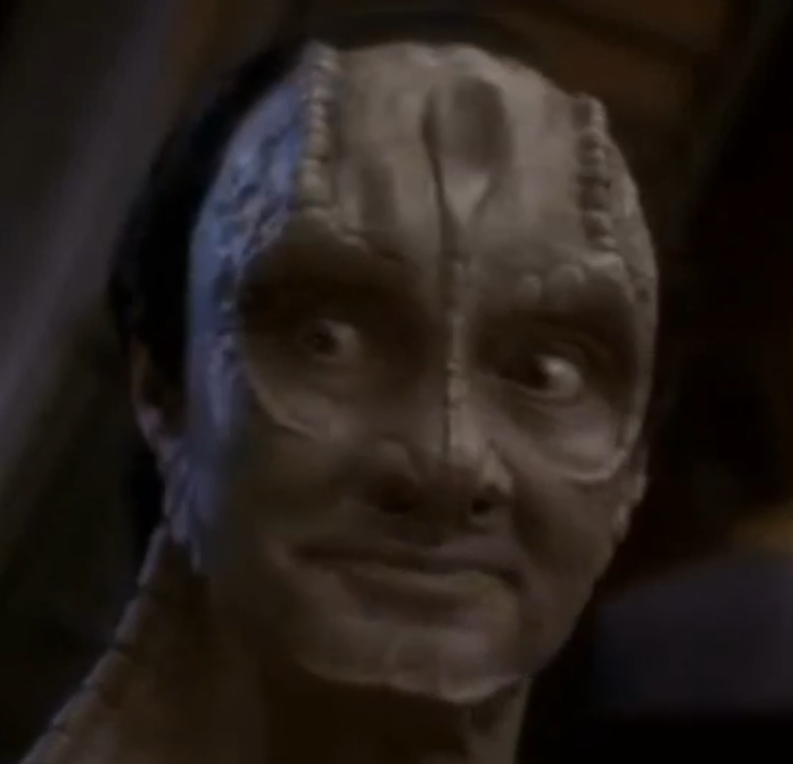 A screenshot of Garak, a character in Star Trek: Deep Space Nine, looking opposite at Odo after telling him a disgusting joke.