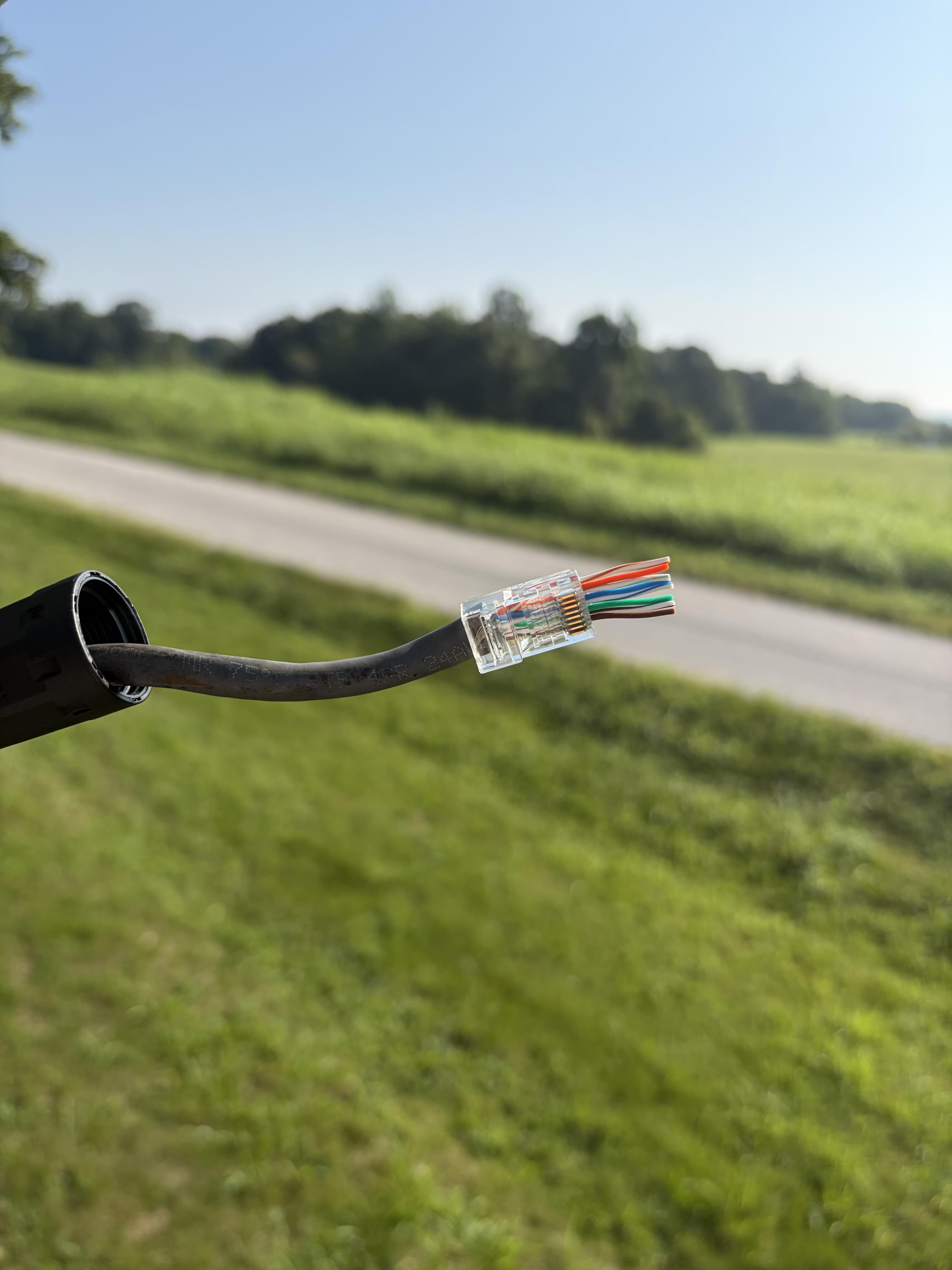 Ethernet cable pulled through the new rj45 connector end out in the yard about 12ft off the ground