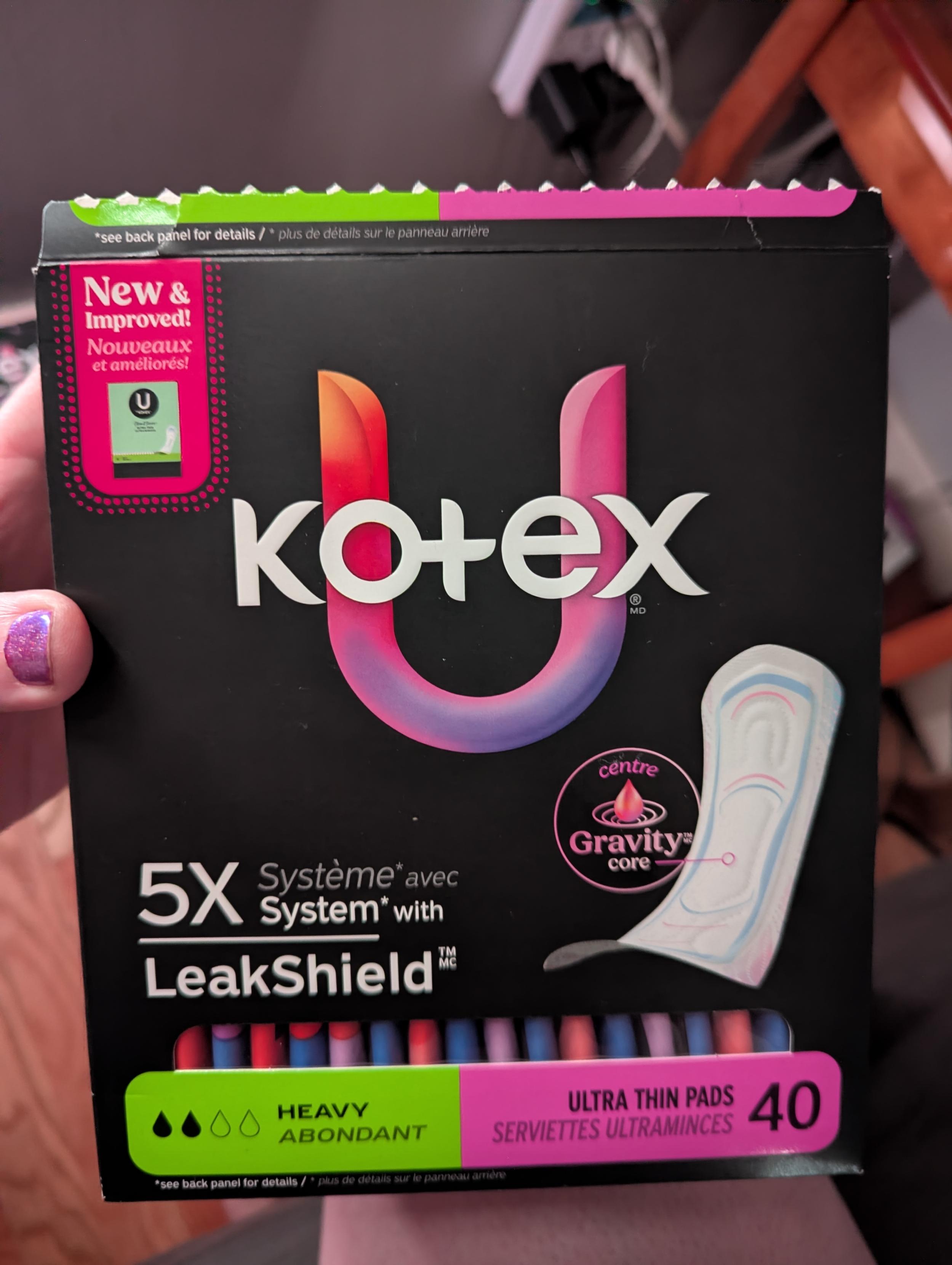 Photo of a box of Kotex U menstrual pads. In the upper left corner is a bright pink note that the packaging is "new and improved". In the lower right corner is the bold number 40, indicating the content count.