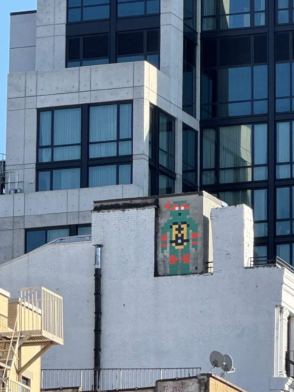 TMNT turtle, pixel art style, painted on building.