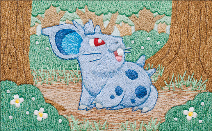 The Pokémon card illustration for the Nidoran♀ card illustration from the Storm Emerelda set. It features Nidoran♀, a blue spotted rodent creature, sitting in a forest clearing, glancing to the right. Bushes with small yellow and white flowers are visible in the foreground, with trees in the background. Instead of traditional drawing methods, all lines are embroidered with thread, resulting in a crafty image with significant texture.