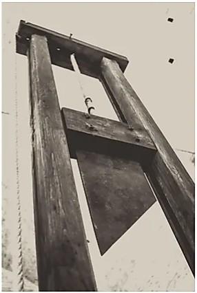An old photo of a guillotine, shot from a dutch angle.