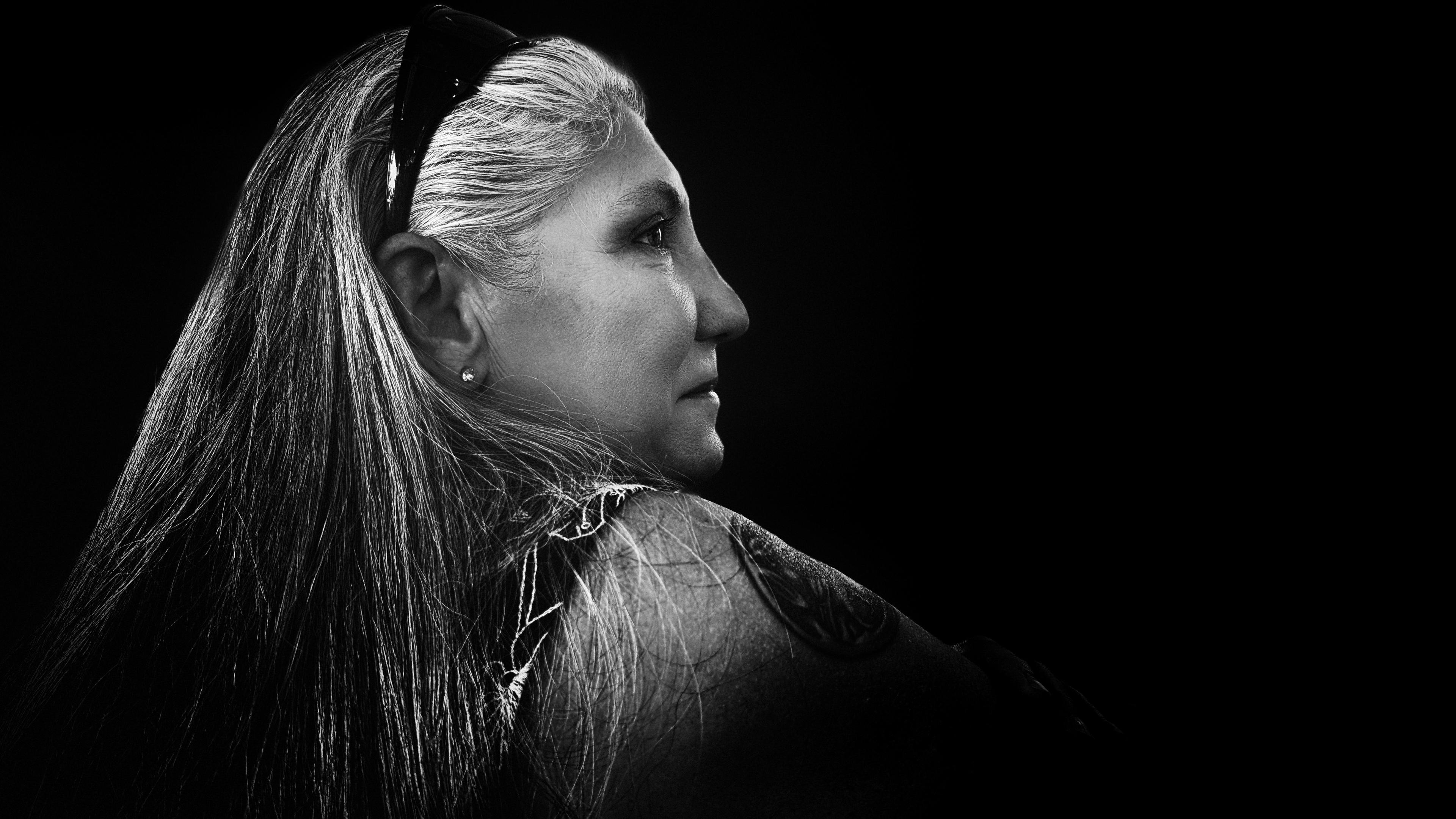 Krissy, looking into the distance, in black and white. The picture was taken at a party and I faded out the background.