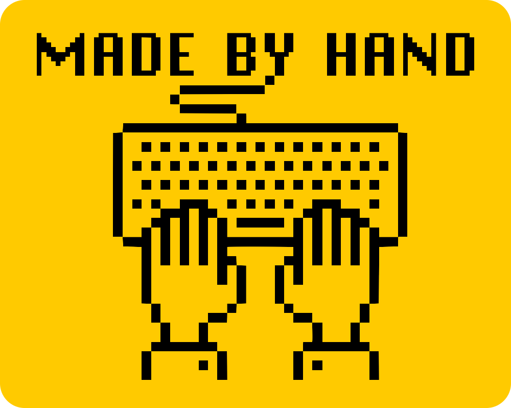 Yellow sticker with a retro pixel style illustration of two hands resting on a keyboard, with the text "MADE BY HAND" above. The keyboard's cable looks like it's snaking down from the "Y" of the text.