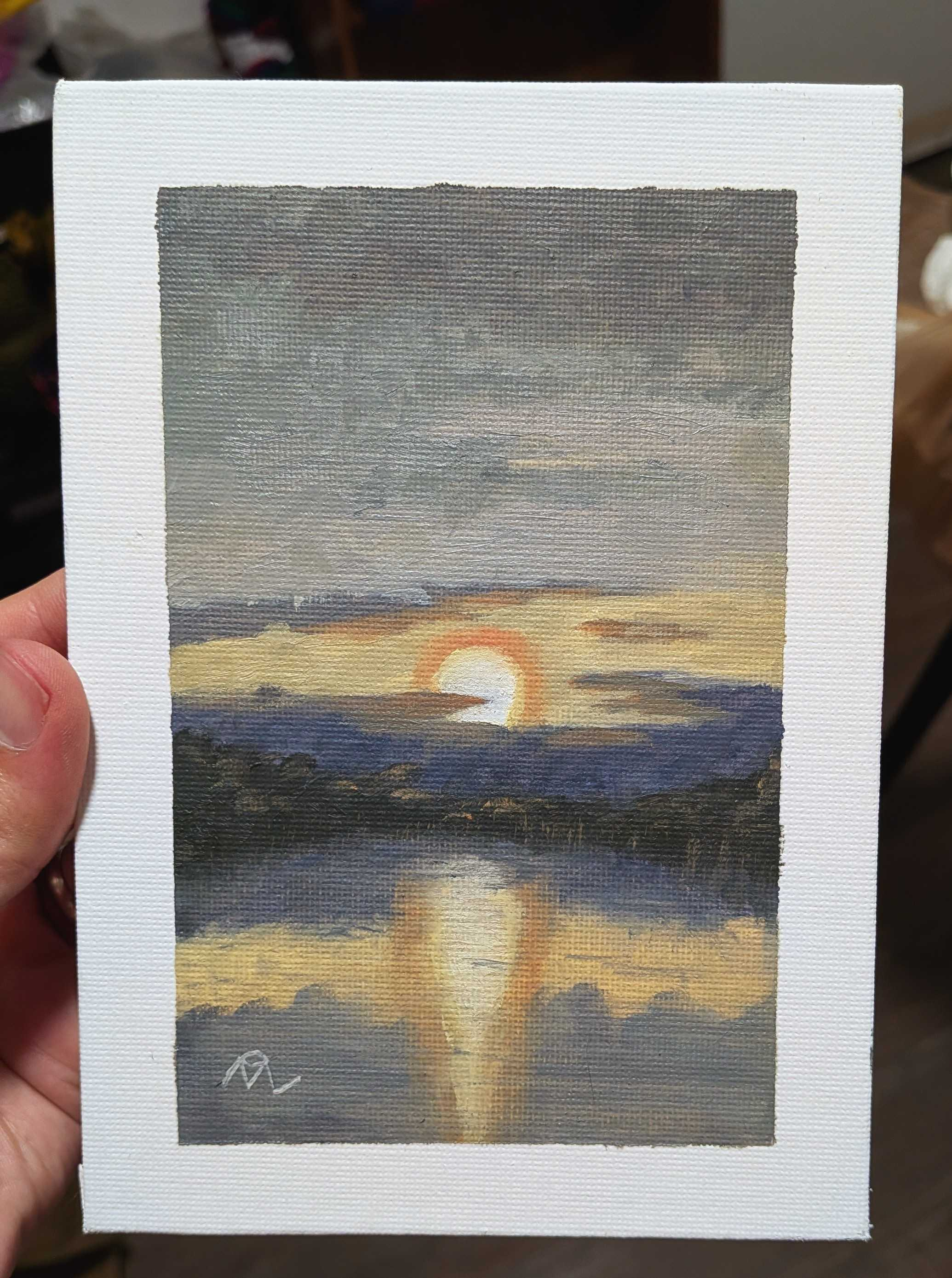 Oil painting on canvas panel showing a setting Sun in a pale sky bordered by bluish grey clouds. The light reflects off the water of a lake bordered by silhouetted trees.