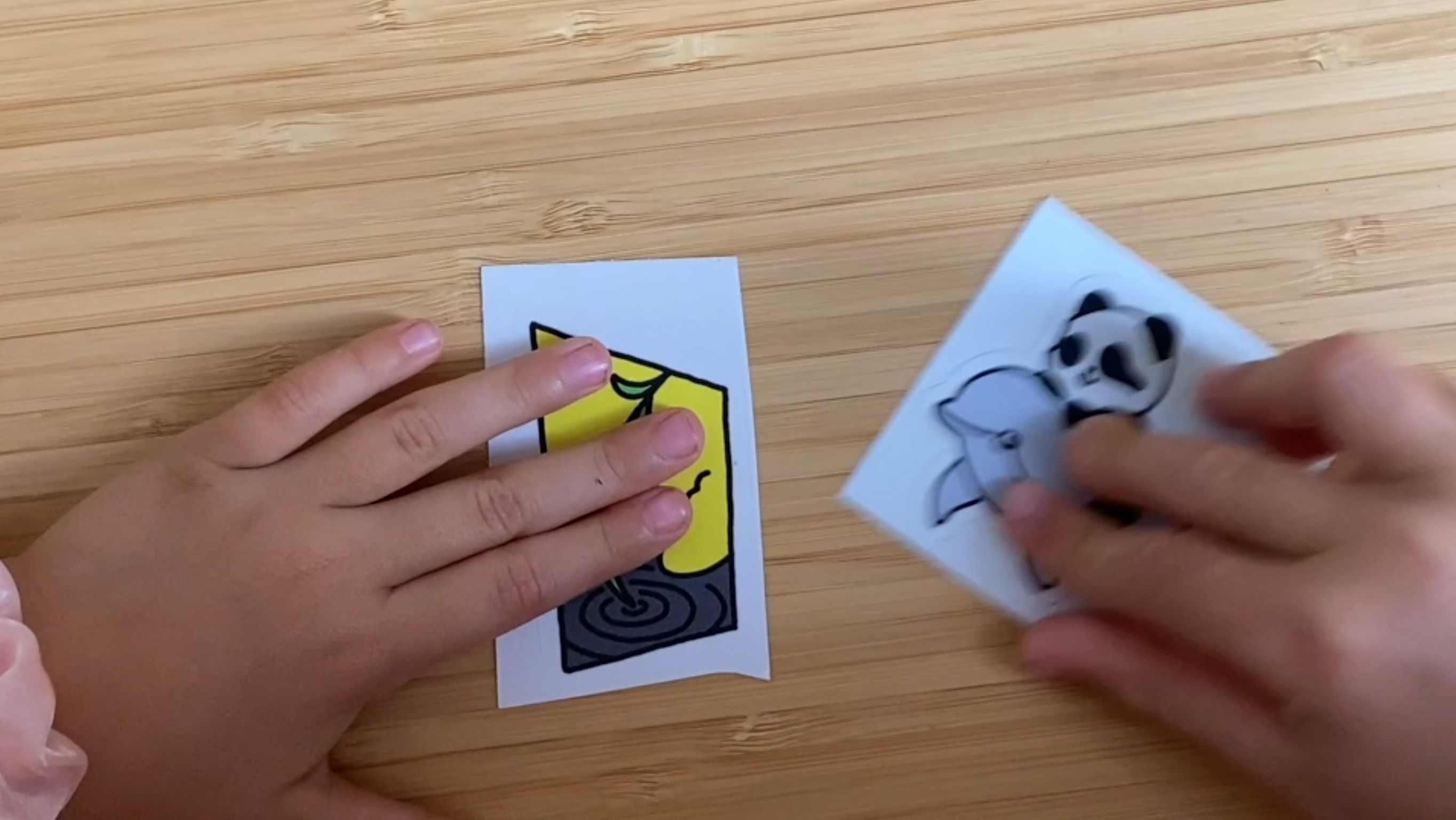 Looking from above at a tabletop, there's two hands coming into the picture from each end, the left one with a Willow sticker, the right one with a p2panda sticker. They try to "merge" but it does not work and ends badly .. but what happens next ..? The panda sticker falls lightly onto a Pillow, directly above Willow. A p2panda + Willow adapter! Yay!