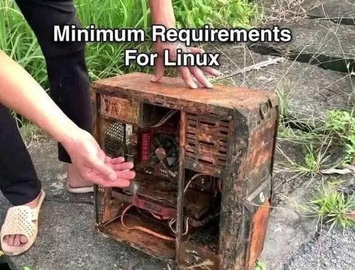 Old, rusty computer tower outdoors with the caption "Minimum Requirements For Linux."