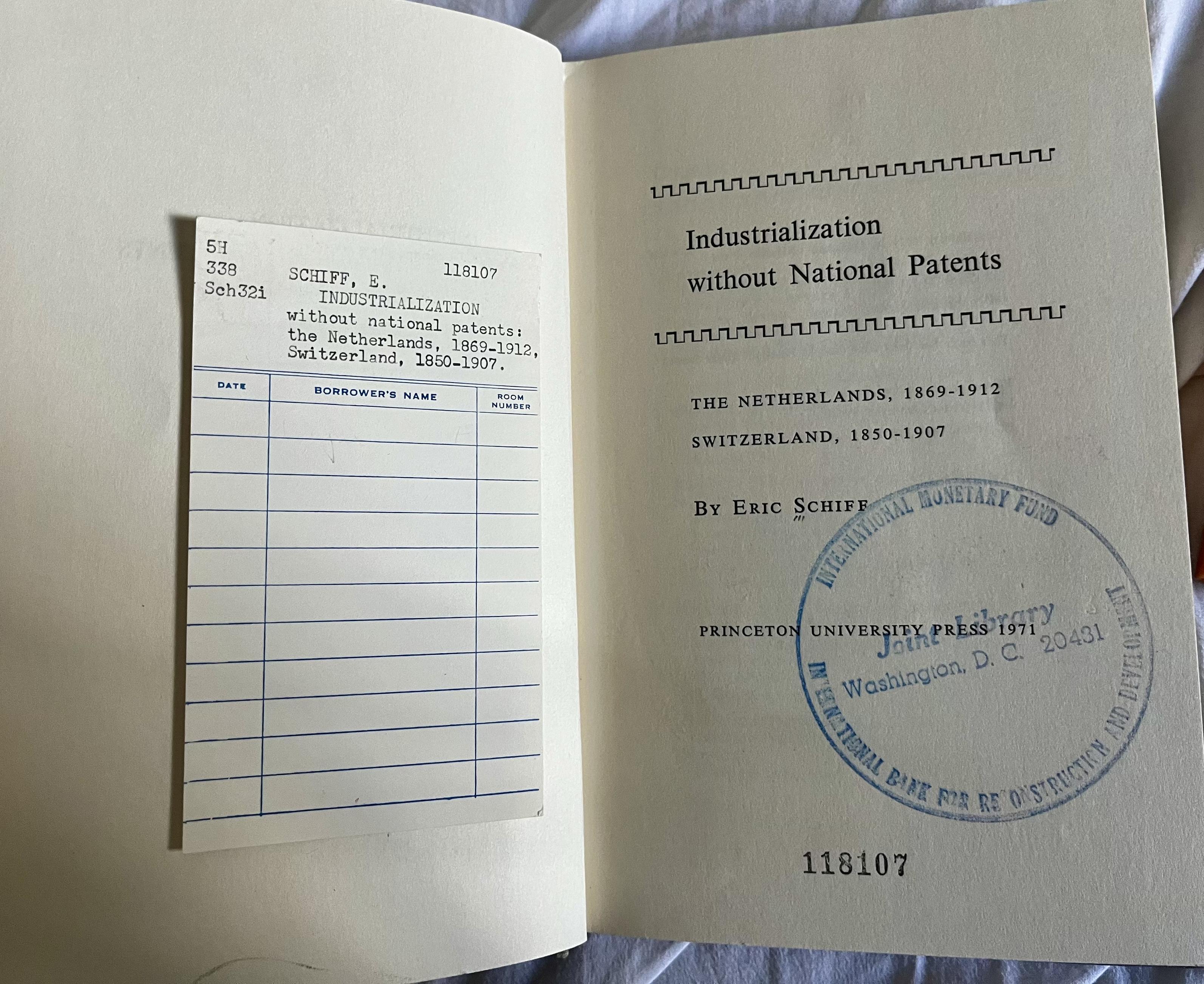 The 1971 first edition „Industrialization Without National Patents“, Eric Schiff, reprint from the Princeton University Press. Opened, showing the library borrower card and the stamp of the joint library of the International Monetary Fund.