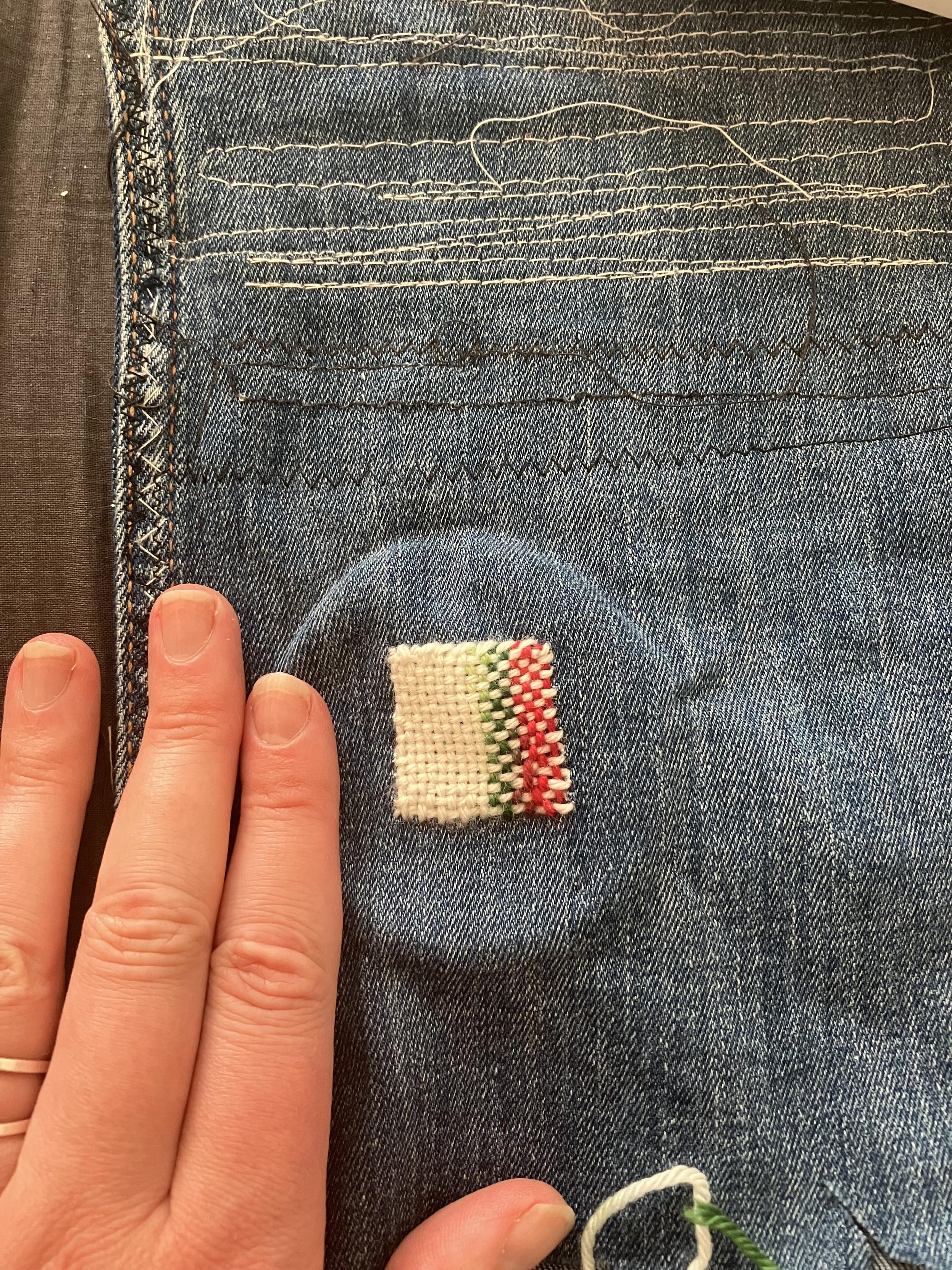 Finished patch with hand for scale. It’s square-ish and just a bit taller than a female fingertip.