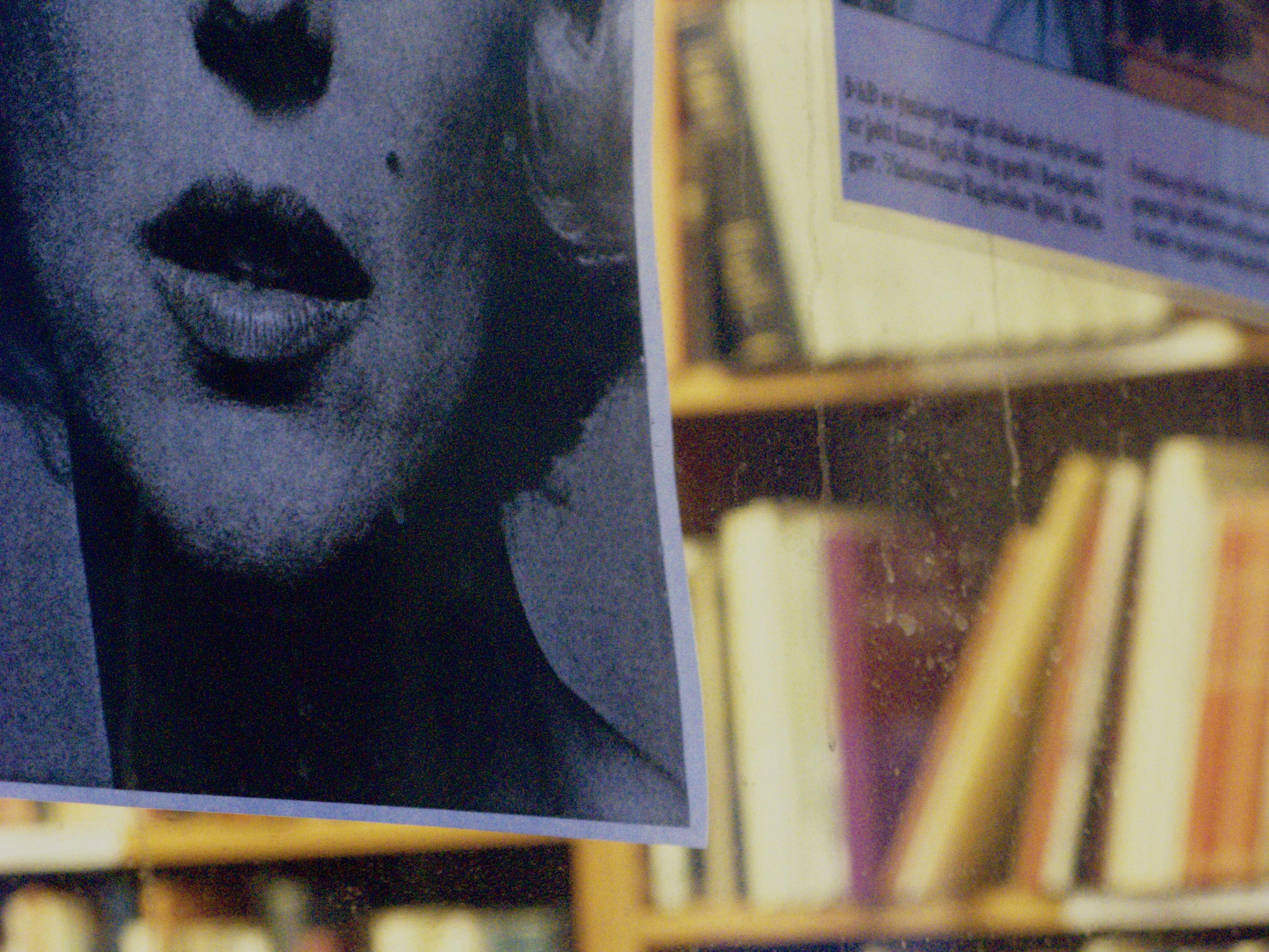 This is a bookshop window. You can see a part of a photo of Marilyn Monroe in the window.