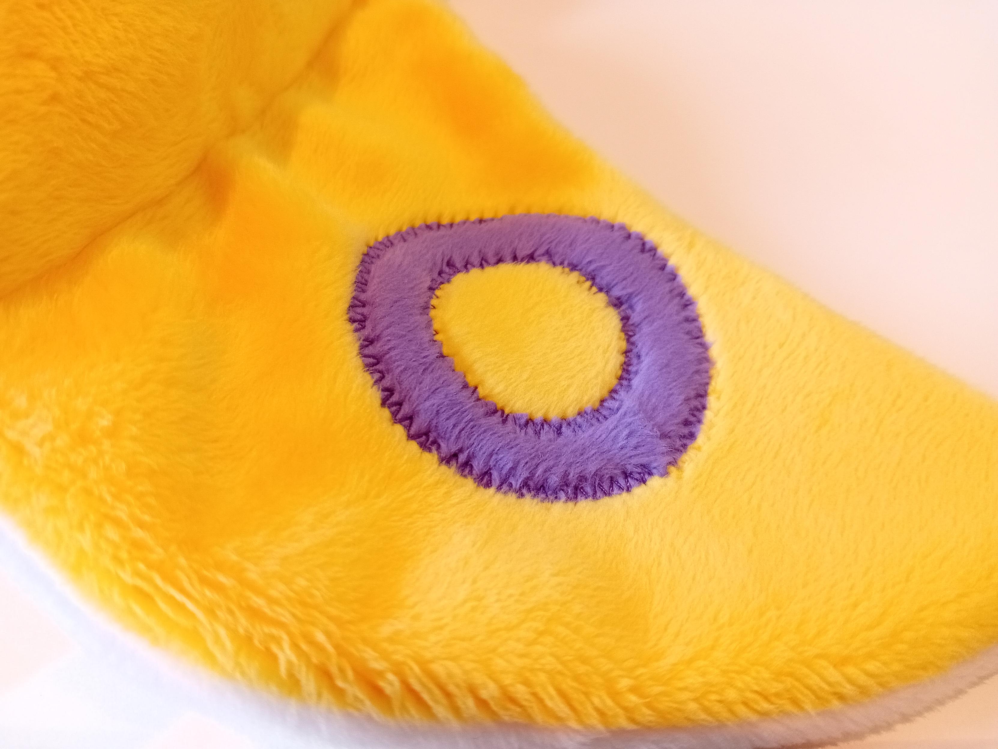 A closeup of the wing, showing the purple ring appliqué that's been zigzag stitched on.
