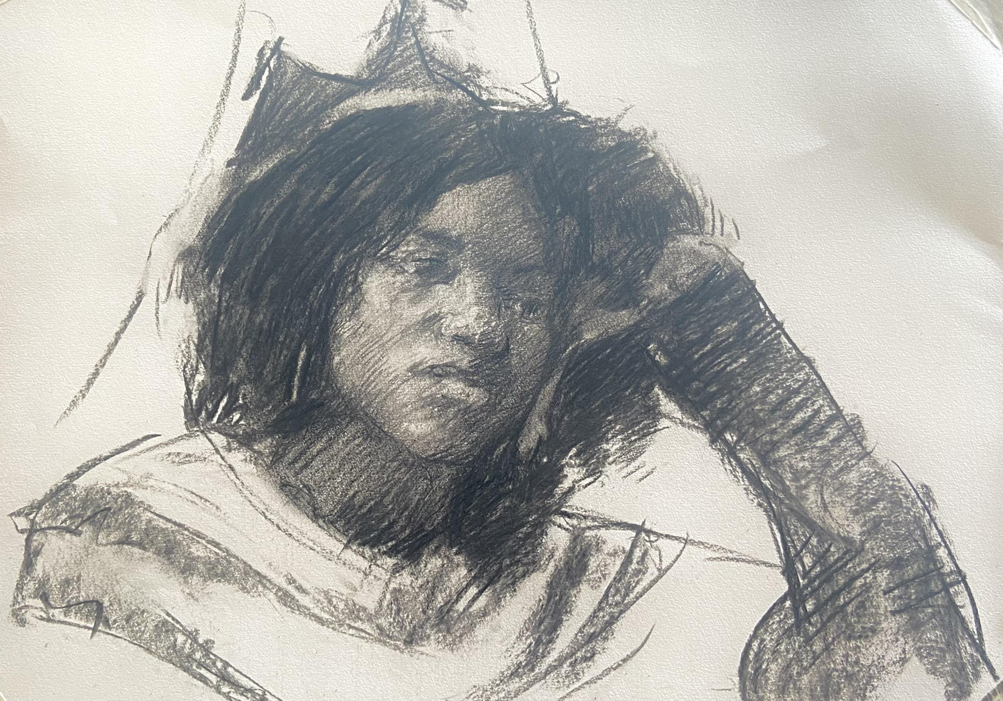 Portrait of a young woman leaning on her hand. It’s done in charcoal.
