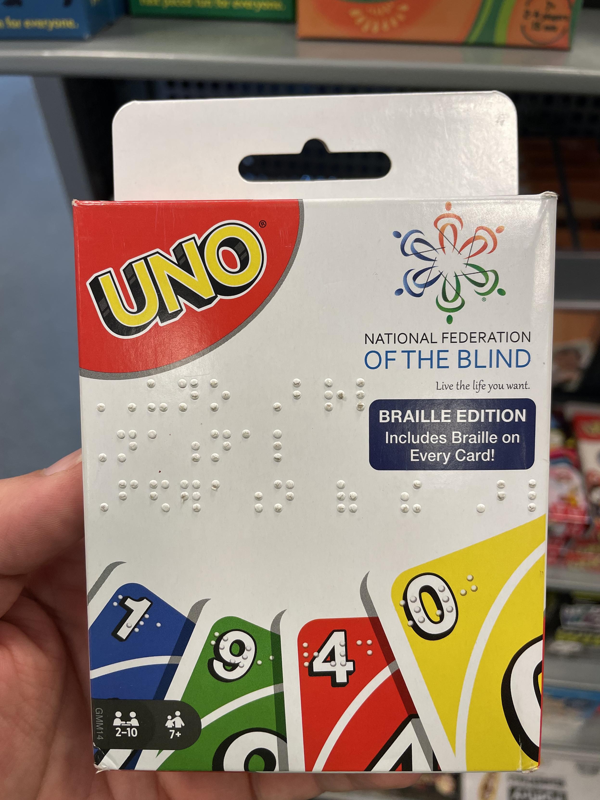 A box of UNO cards, embossed in Braille, containing cards that are also embossed in Braille.