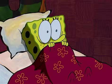 SpongeBob terrified in bed holding the covers tight.