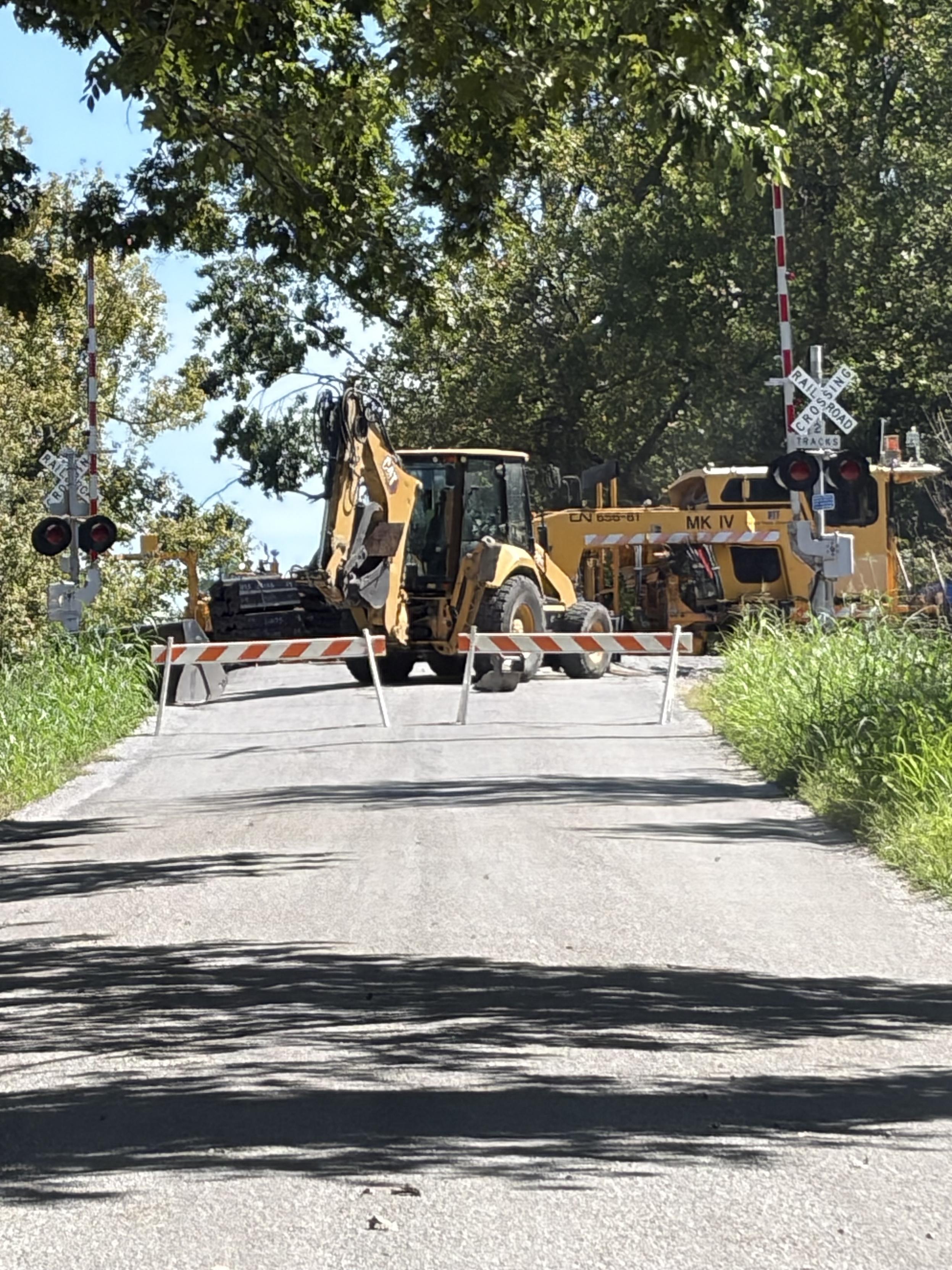 Railroad crossing blocked with construction equipment.