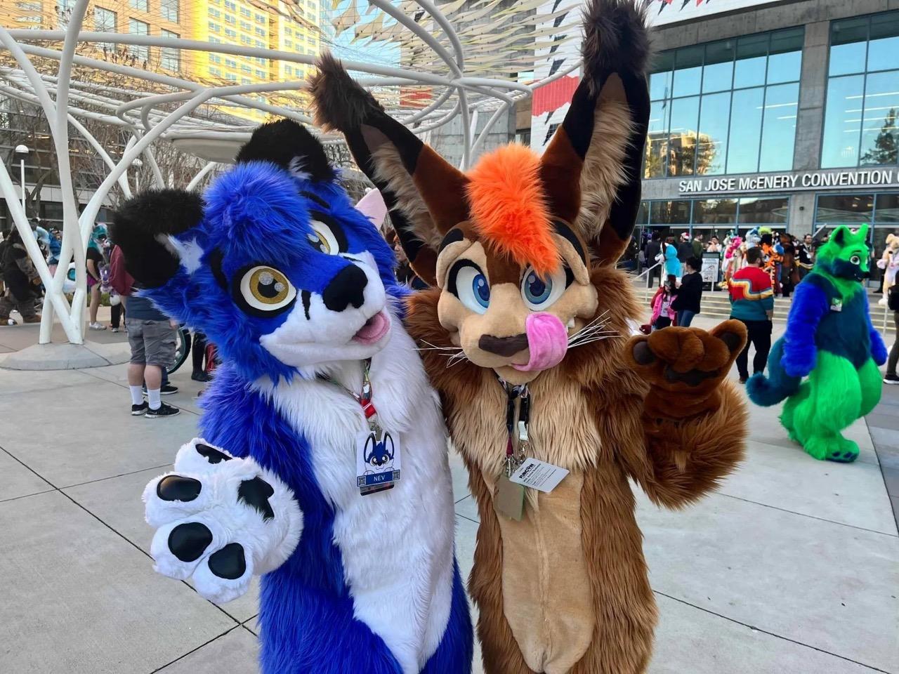 Two fursuiters pose outside on a warm winters day