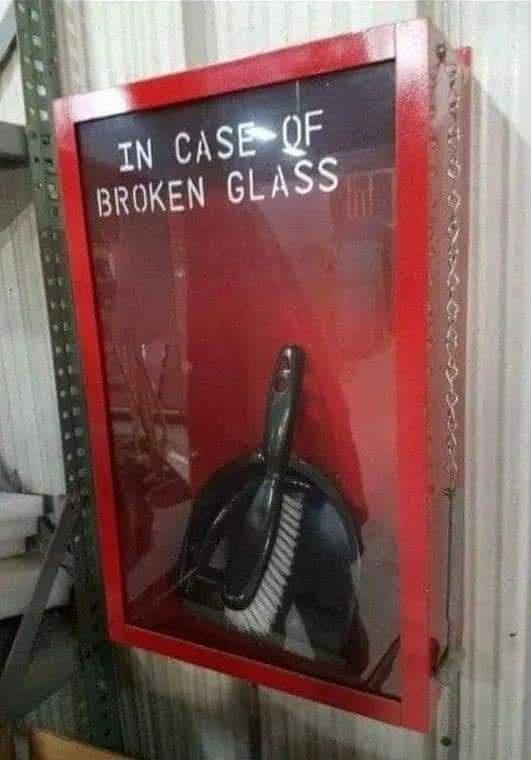 Red case with an emergency, breakable glass cover containing a hand broom and dust pan.  IN CASE OF  BROKEN GLASS