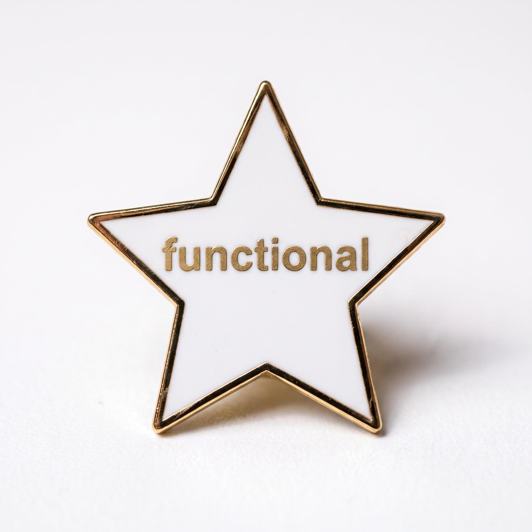 A white star-shaped enamel pin with gold trim, featuring the word "functional" written in gold lowercase letters across the center.