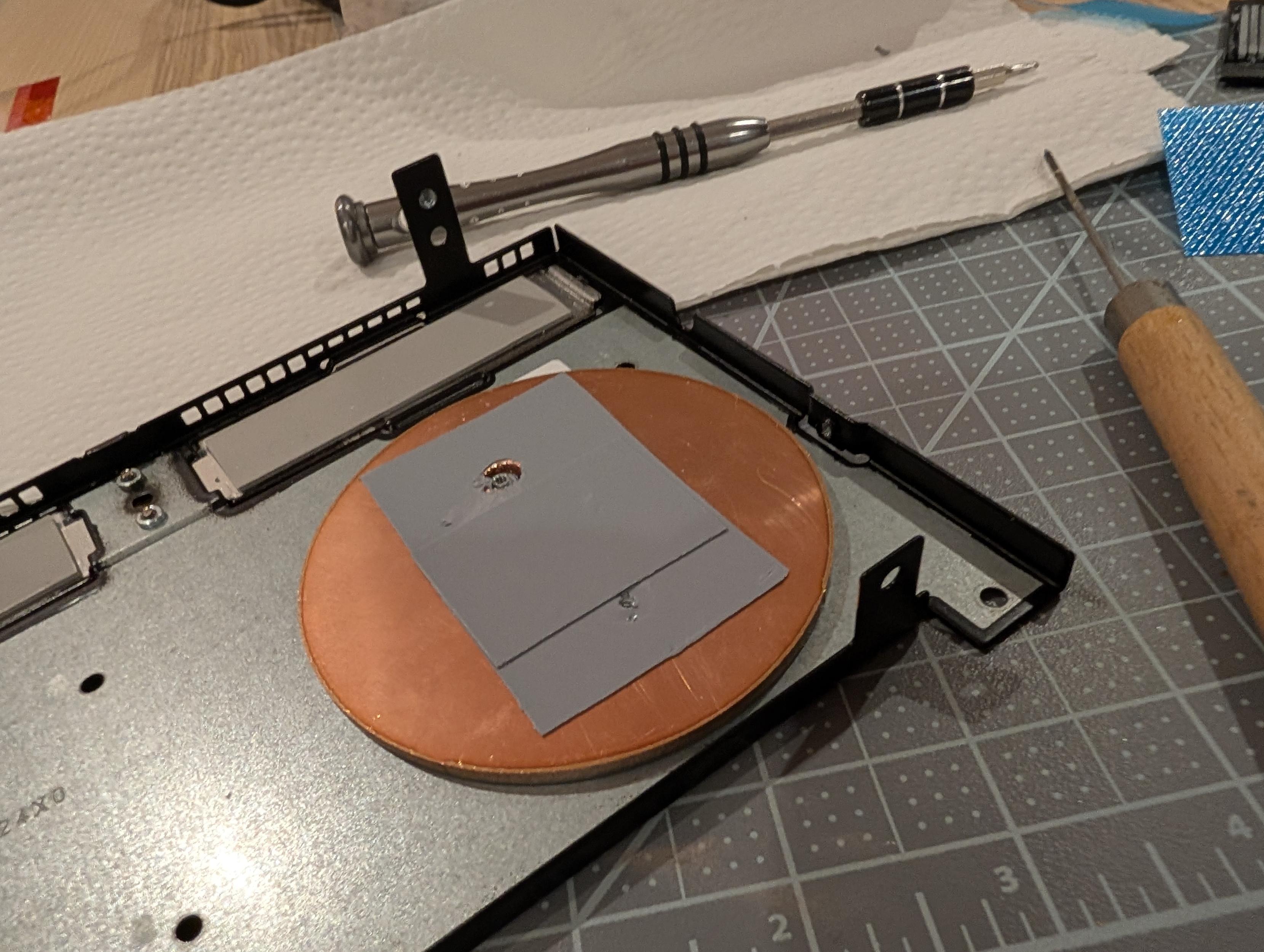 A 3mm copper disc, drilled out to accommodate existing screw taps, is mounted directly against the back plate using PTM for contact and 13w/m.k pads for chip contact.