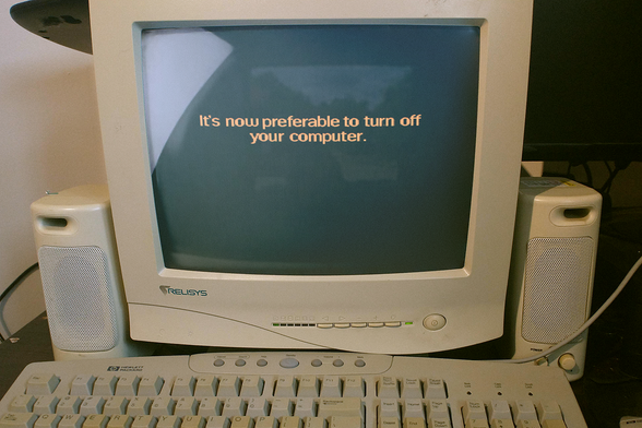 A picture of a beige PC era screen with speakers and keyboard to suit, and the text "It's now preferable to turn off your computer"