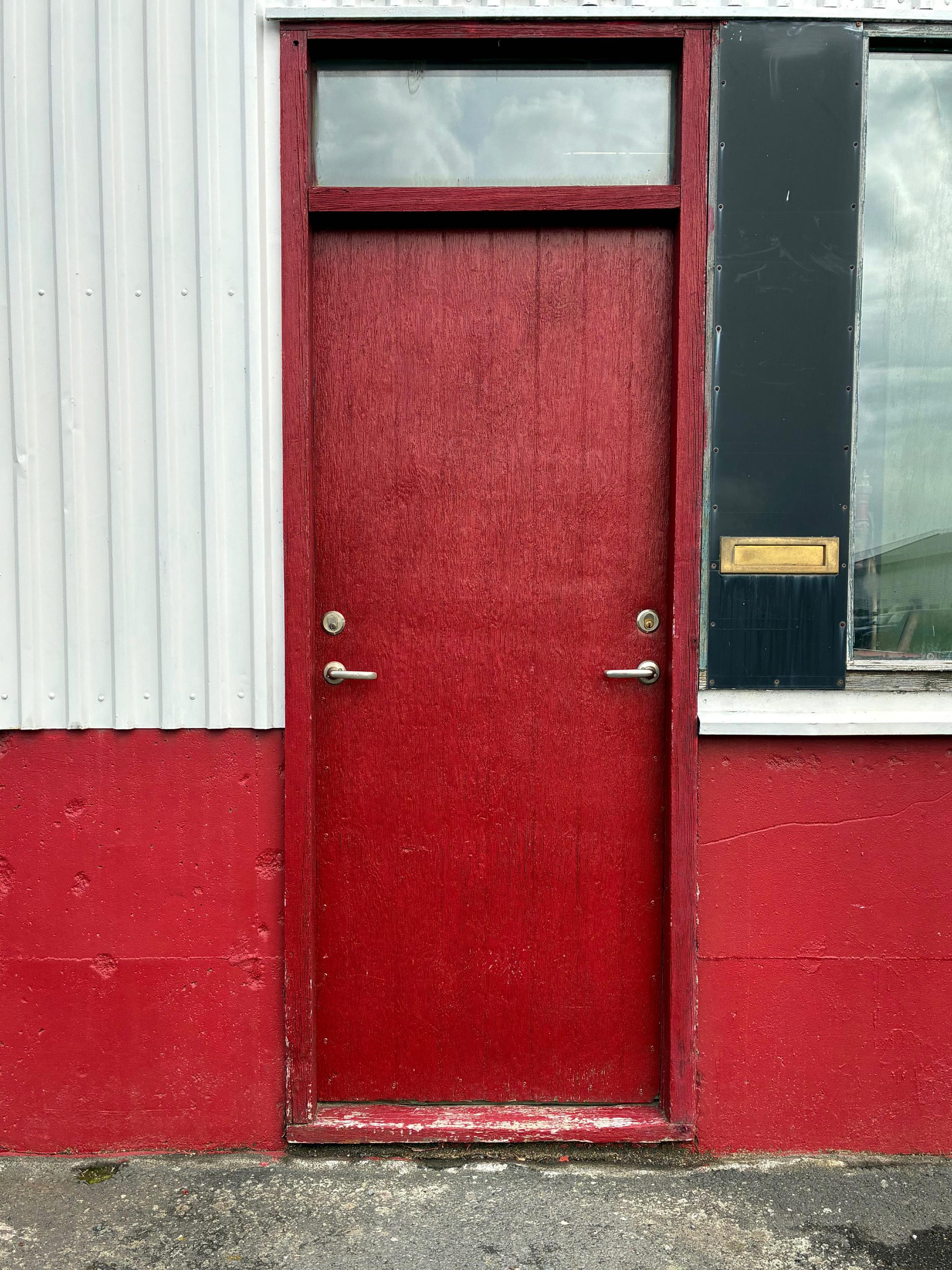 A red door with two door handles.