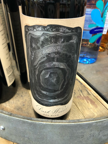 a wine bottle with an image of a black hole