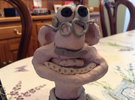 an even more poorly made head of wallace from wallace and gromit, covered in bits of hair and with off-model accessories including glasses and a grey moustache