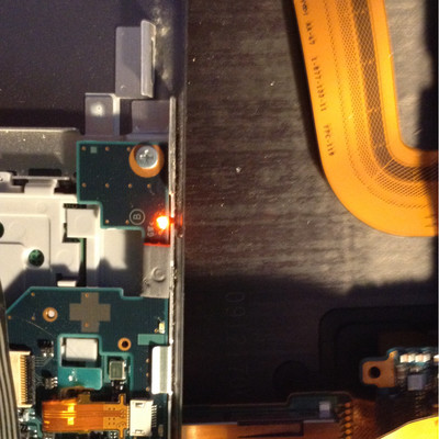 glowing LED on a  keyboard assembly, indicating battery  charging