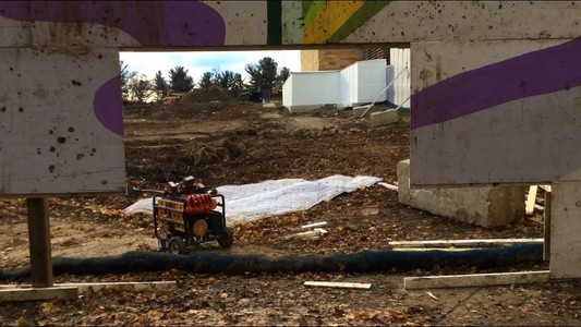 a dirt pile through a hole in a wall