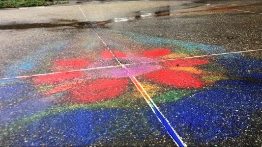 a colorful flower drawn on the ground
