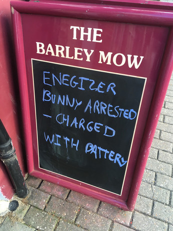 pub sign reads “Energizer bunny arrested - charged with battery”