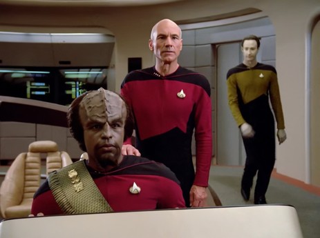 Data, who just got lucky, swaggering towards Jean-Luc Picard