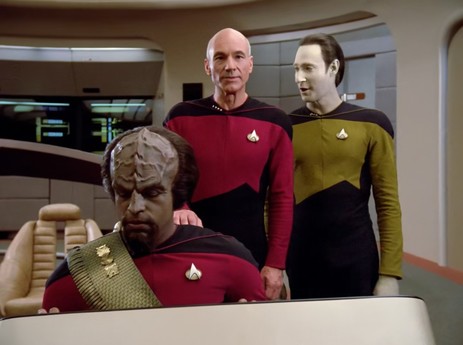 Data talking to Jean-Luc Picard while looking naughty.